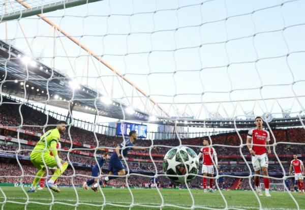 Le gardien d'Arsenal David Raya regarde le ballon dans son but après l'ouverture du score par Ousmane Dembélé en demi-finale aller de Ligue des champions, le 29 avril 2025 à Londres 