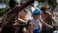 Un groupe d'adolescents asperge d'eau un jeune homme circulant en scooter près du canal Saint-Martin, à Paris, le 24 juin 2026