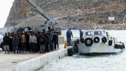 Des migrants débarquent d'un bateau au port de Kali Limenes, à Héraklion, dans le sud de la Crète, le 21 février 2026