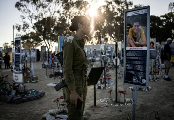 Une soldate israélienne se recueille au mémorial des victimes de l'attaque du Hamas à Réïm, dans le sud d'Israël, le 7 octobre 2025, jour du deuxième anniversaire de l'attaque