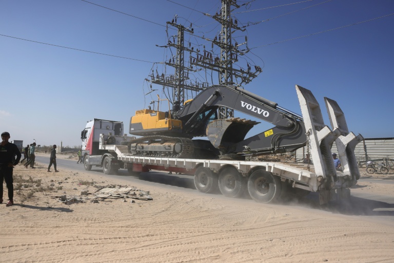 Des engins de chantier arrivent dans la bande de Gaza pour participer aux recherches des dépouilles d'otages, à Deir el-Balah le 27 octobre 2025